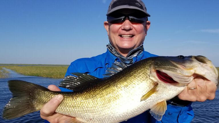 Angler holding a large Lake Okeechobee bass in November