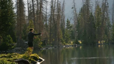 Fall bass fishing strategies at a serene alpine lake in Utah at dawn.