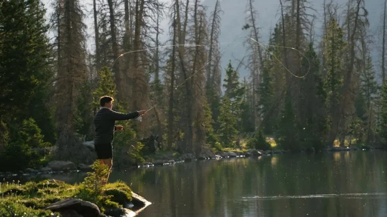 Fall bass fishing strategies at a serene alpine lake in Utah at dawn.